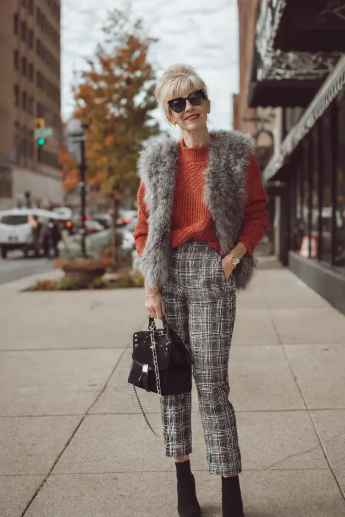 mom outfits, fur vest, checked plaid pants, burnt-orange top