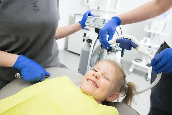 young girl winking in dentist chair - scared of the dentist