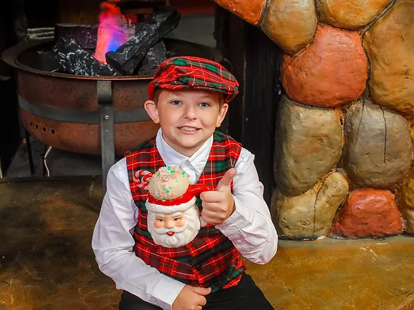 creating a child allergy action plan - young boy with a mug of hot cocoa by the fire place