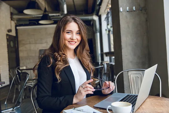 which job pays the most - woman at laptop with glasses in hand