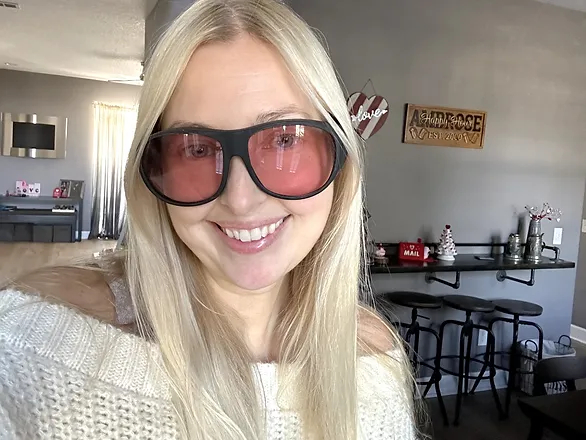 blonde woman smiling, wearing FL-41 tinted glasses
