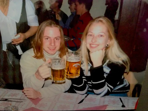 man and woman holding beer steins