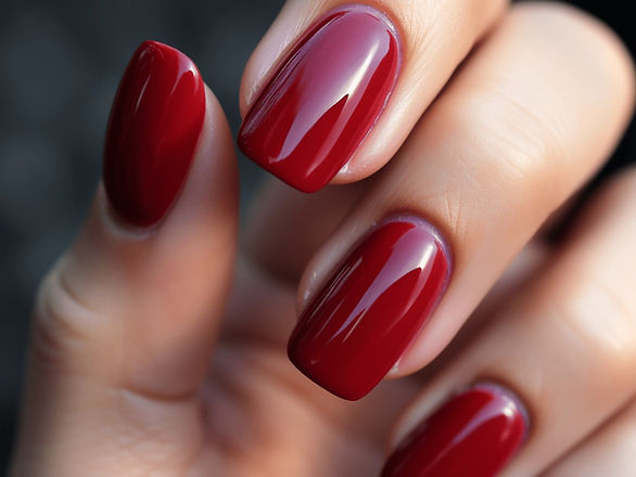 Vibrant Red Sophistication: This image captures the bold sophistication of vibrant red nails. The nails are of medium length, perfectly shaped, and boast a high-gloss finish, reflecting a sense of confident style.