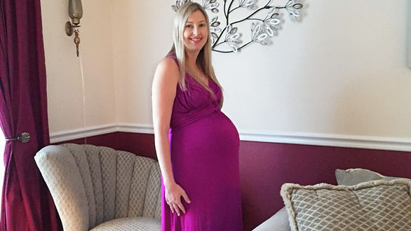 pregnant woman in purple dress - pregnancy common questions