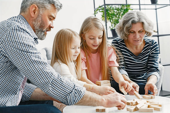 family bonding activities - grandparents playing game with two girls