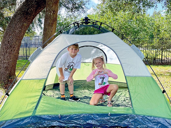 boy and girl in a green tent - family bonding activities