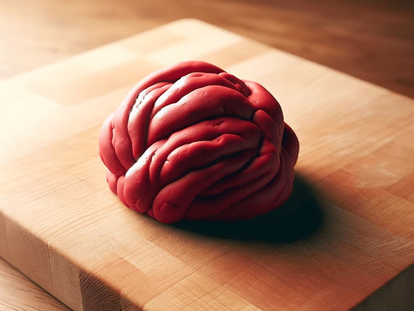 red lump of playdough on butcher block