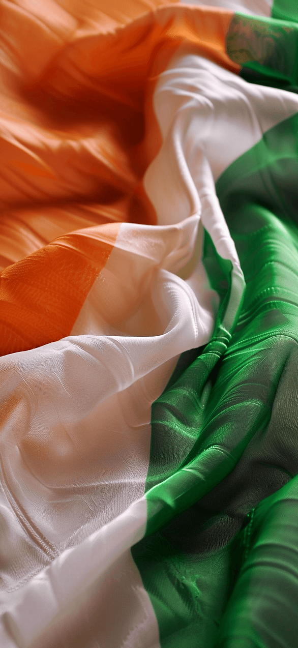 Irish Flag Waves: The Irish flag gently waving, with a focus on its vibrant green, white, and orange colors, symbolizing peace and unity.