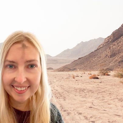 What should I give up for lent? Woman with an Ash Wednesday cross on her forehead, with a desert scene in the background. 