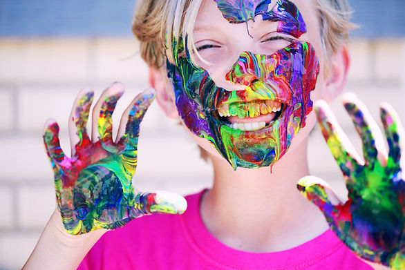 kid with messy paint on their hands, face, and teeth - yes day
