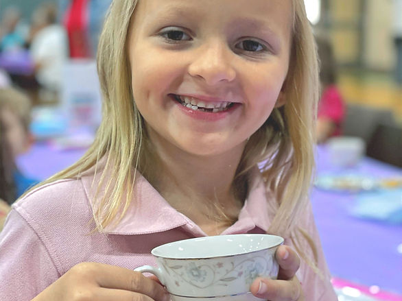 girl smiling with tea cup in hands