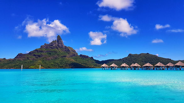 vacation to Bora Bora - overwater bungalows and mountain in the background
