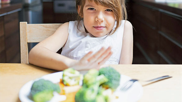 kid pushing plate of food away - dealing with picky eaters