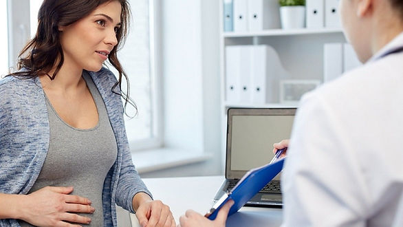 pregnant woman consulting with doctor - choosing an obgyn