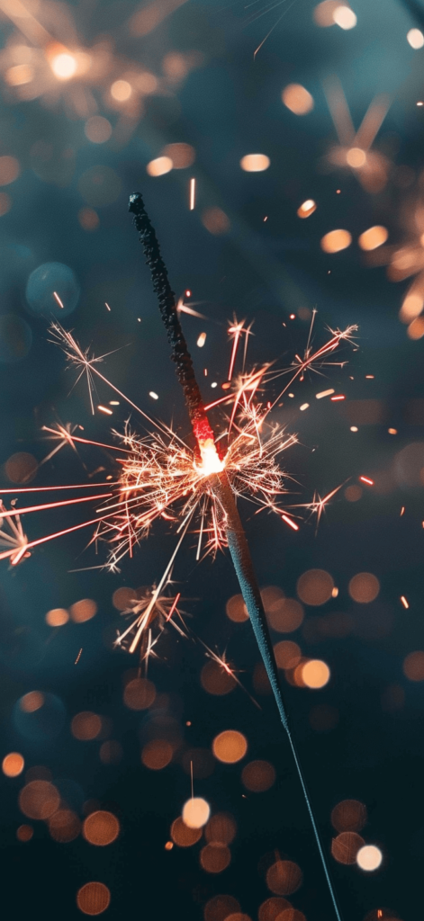 A close-up shot of sparklers burning bright, evoking memories of summer nights and festive celebrations. American iPhone wallpaper.