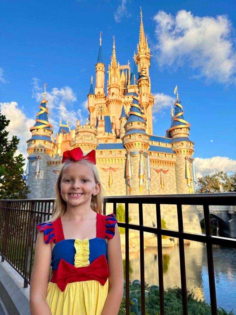 girl infront of the castle dressed as Snow White