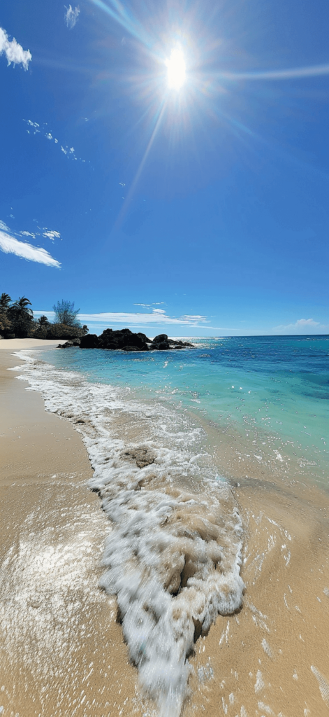 A serene beach with crystal-clear water and a bright blue sky. Summer wallpaper. 
