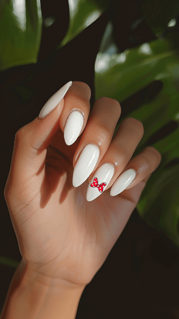 white nails with ring finger with minnie bow;m Disney nails