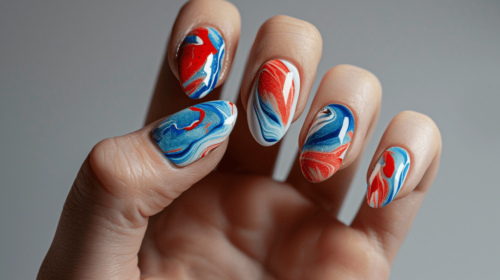 A realistic photo of a human hand with five fingers, each nail showcasing a red, white, and blue water marble design.