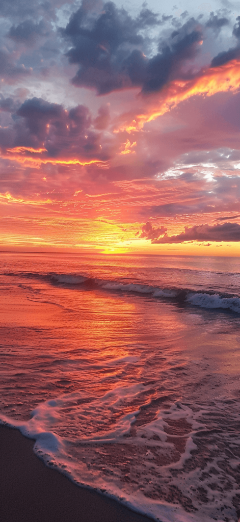 golden hour on a sandy beach as the sun dips below the horizon. Summer wallpaper. 

