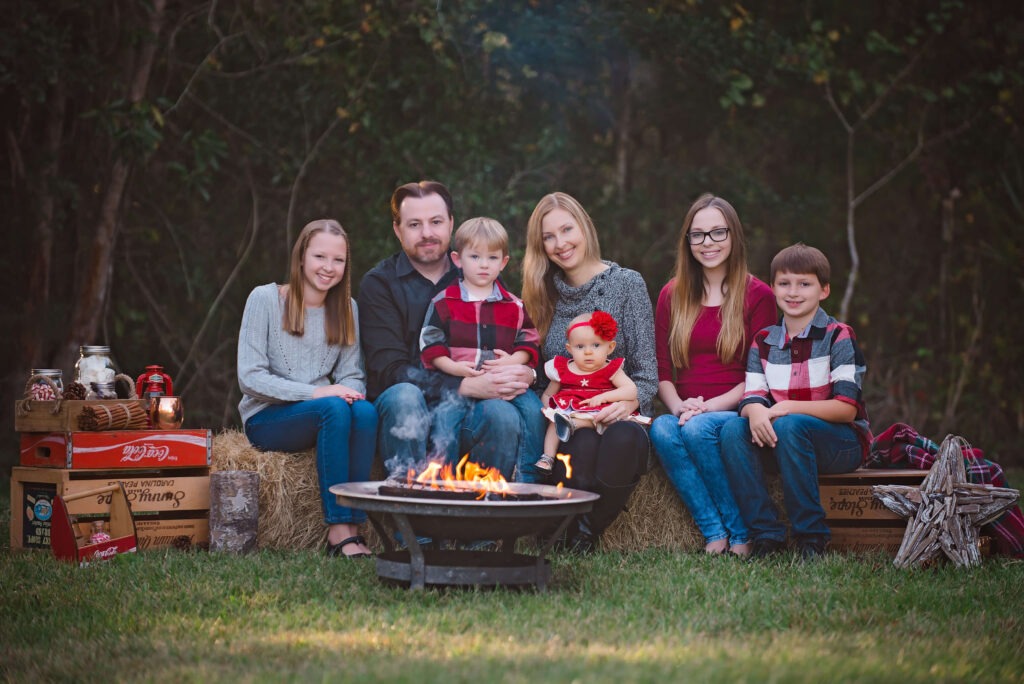 family of 7 sitting around a fire