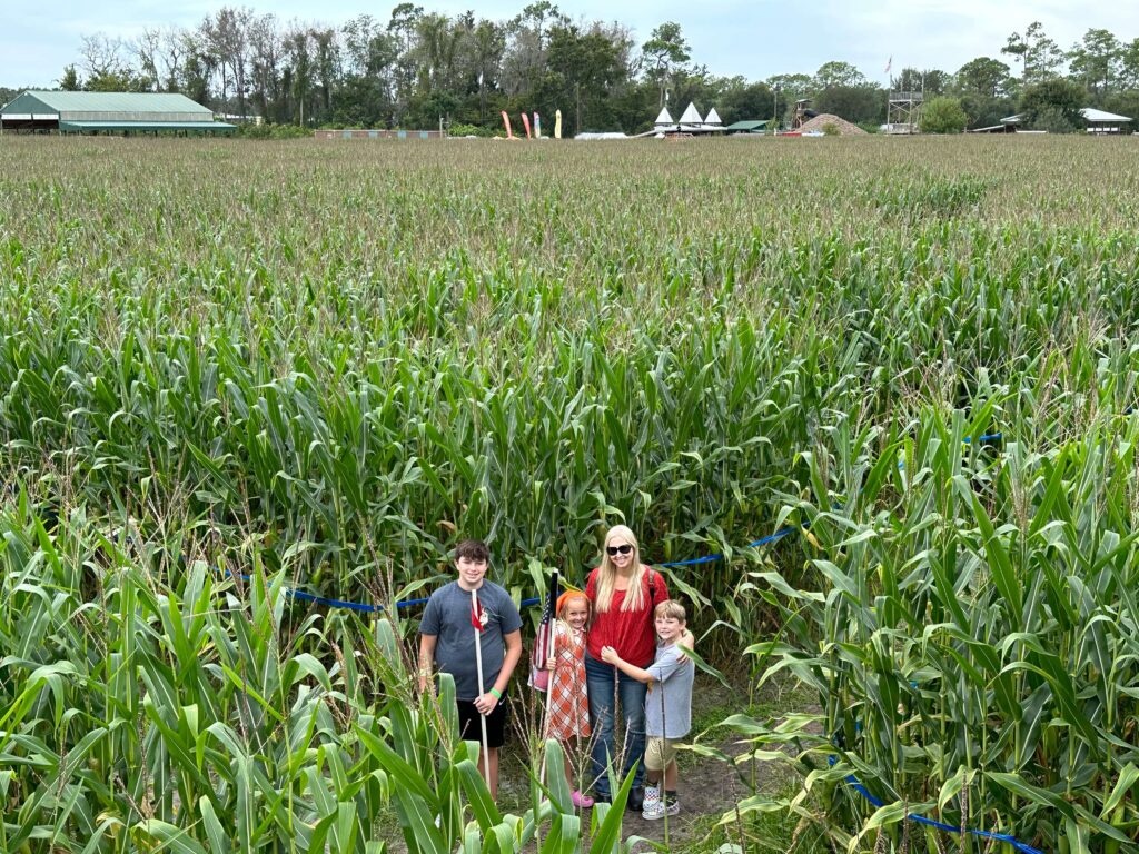 mom and three children in a corn maze; fall bucket list