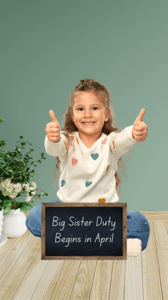 big sister is sitting on the floor with big sister sign and two thumbs up