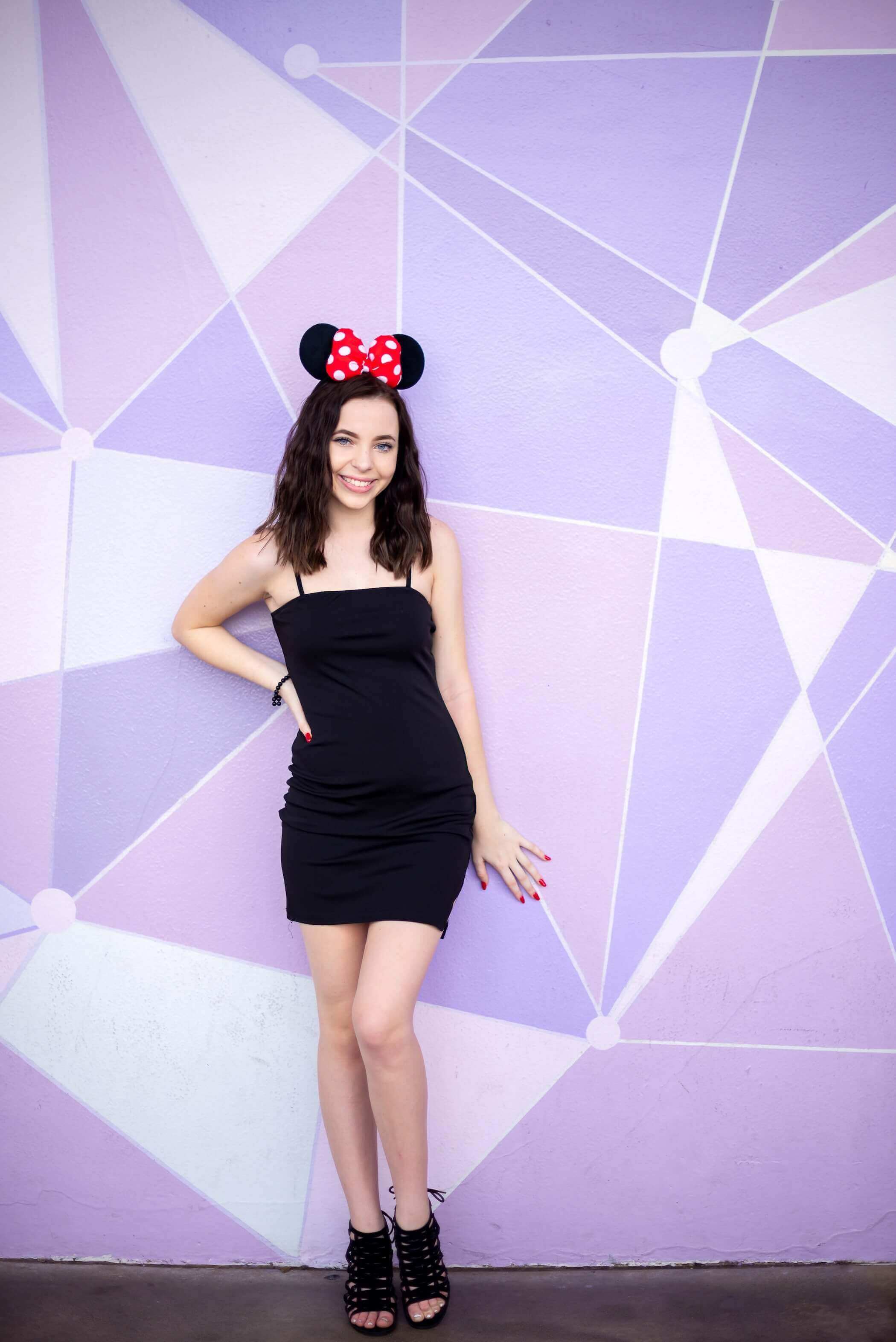 purple wall Disney aesthetic woman with Minnie Mouse ears