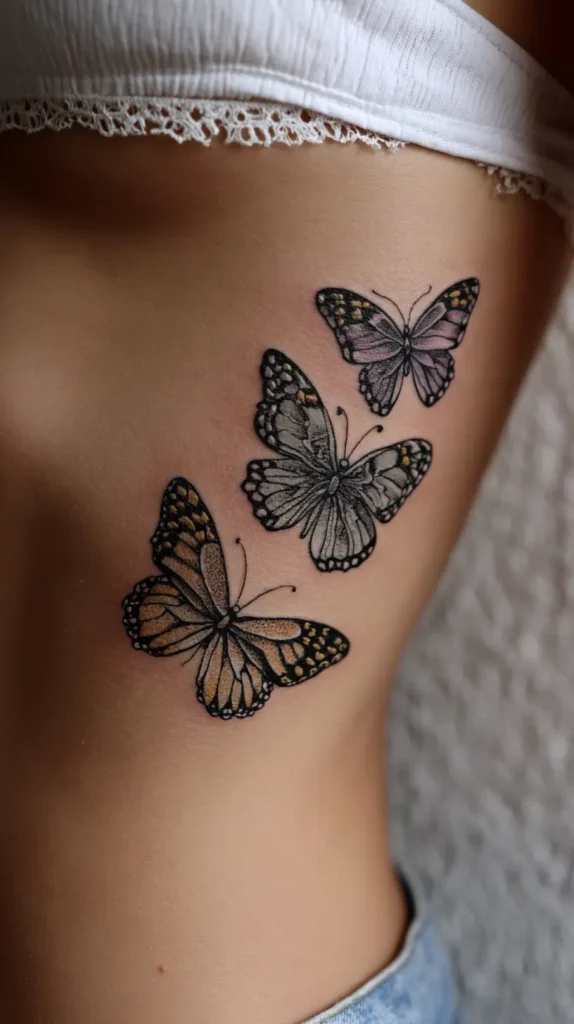 three butterfly tattoos going up a rib cage of a woman
