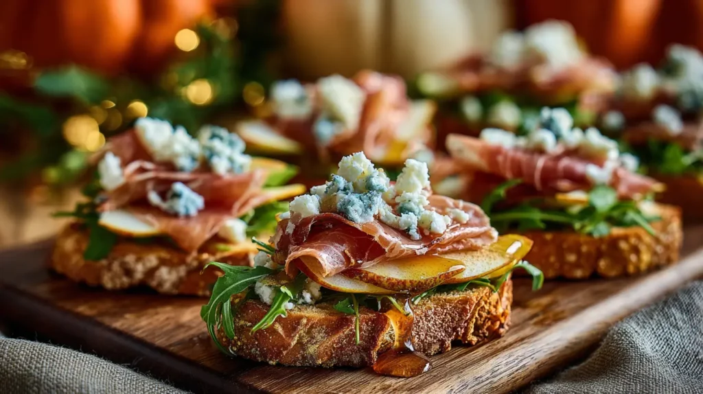 hyper-realistic photo of crostini layered with thin pear slices, ribbons of prosciutto, crumbled blue cheese, and arugula, drizzled with honey, arranged close on a rustic wooden board, background with pumpkins, fall foliage, and a cozy linen napkin, image needs a high bright exposure, no shadows