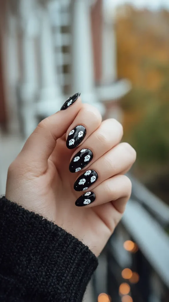 black base manicure with small white ghosts
