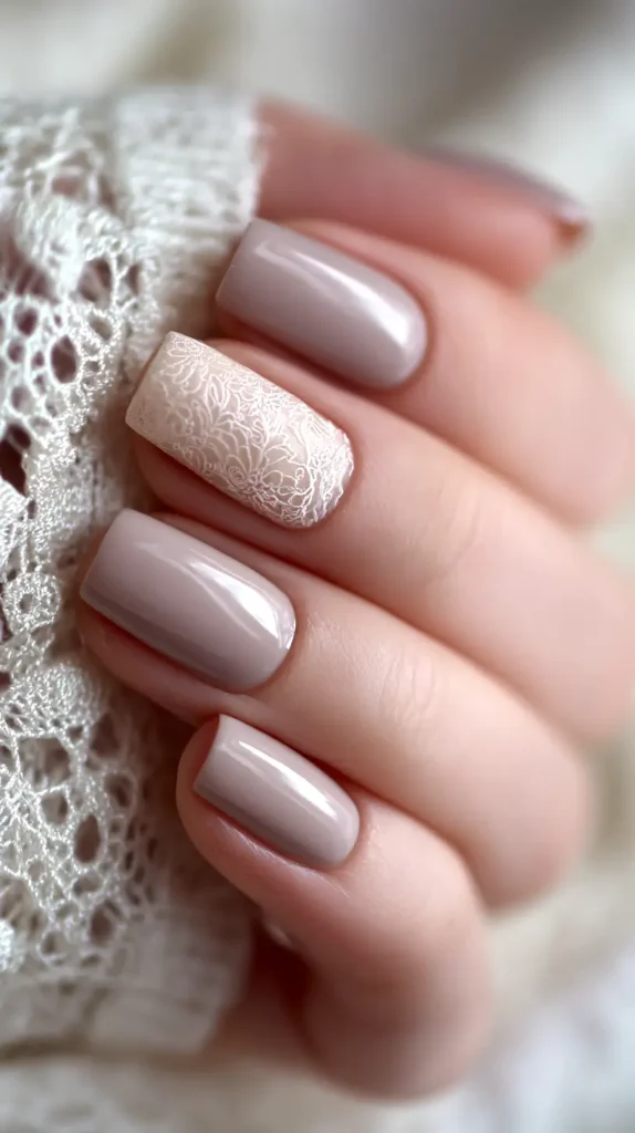 taupe nails with one accent nail detailed in lace