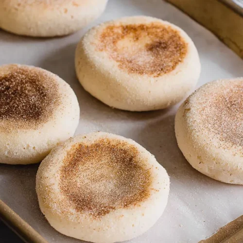English muffins on a baking tray
