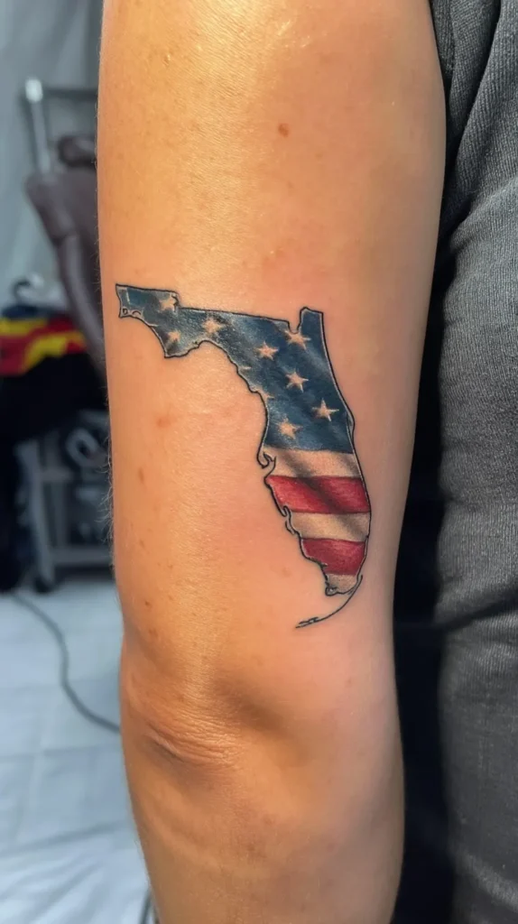 small state of Florida outline tattoo, on a female arm, filled in with the American red, white, and blue flag