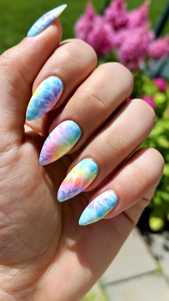 pastel tye-die, birthday-theme nail design manicure on a teenage female hand