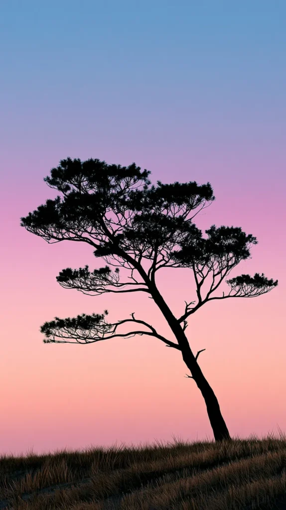 Hyper-realistic vertical phone wallpaper of a single graceful tree silhouette against a soft pastel sky, simple clean composition, gentle natural gradient, open negative space, no people, no animals, no buildings, no words, no text, wallpaper