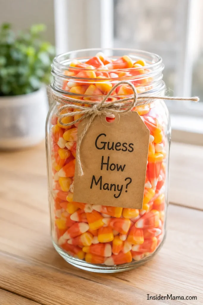 Mason jar filled with candy corn tied with twine and kraft paper tag reading "Guess How Many?